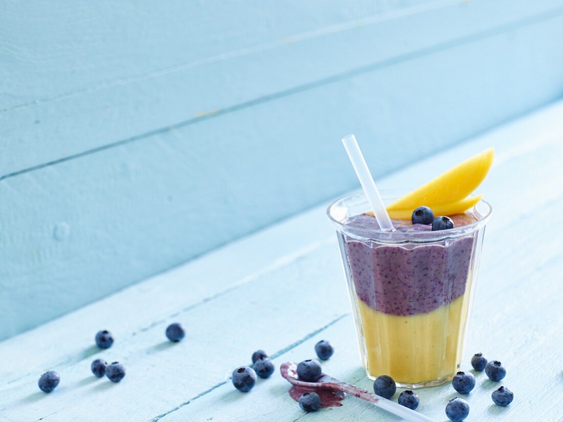 A mango and blueberry smoothie with yoghurt