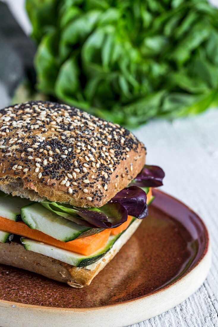 A vegan burger with fresh vegetables on a rustic background