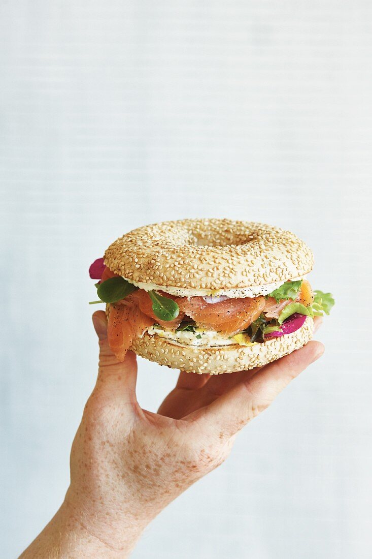 A smoked salmon bagel with wild herbs and cream cheese