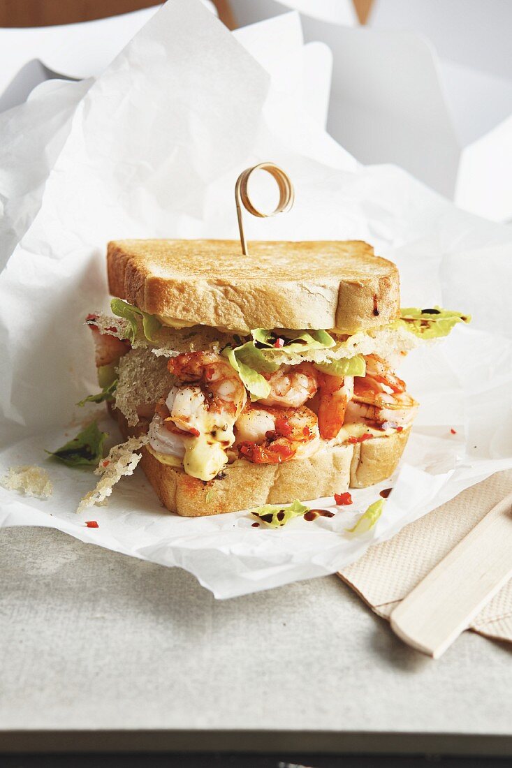 A sandwich with fried rice noodles, prawns and passion fruit mayonnaise