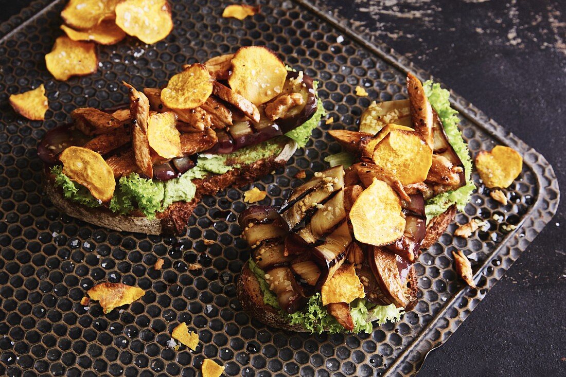 Spelt bread topped with roast chicken breast, aubergine and sweet potato crisps