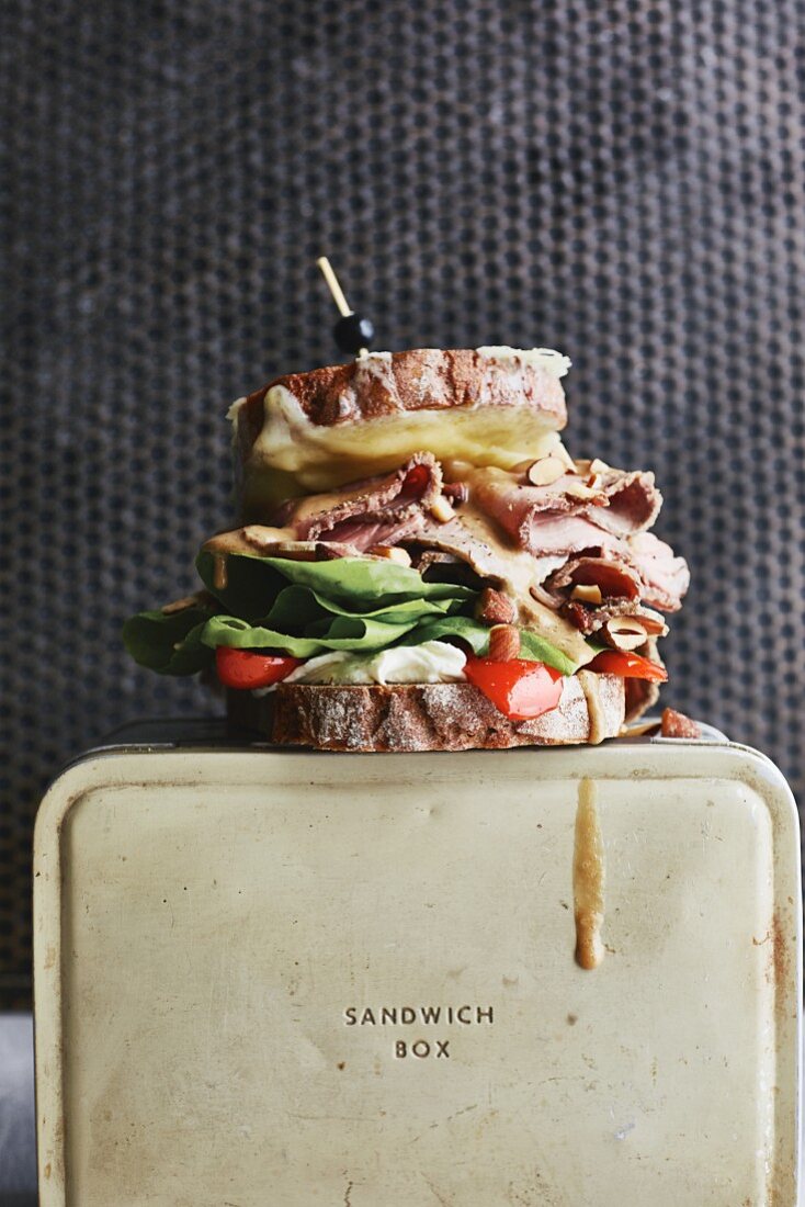 An open sandwich with roast beef, cheddar and smoked almonds