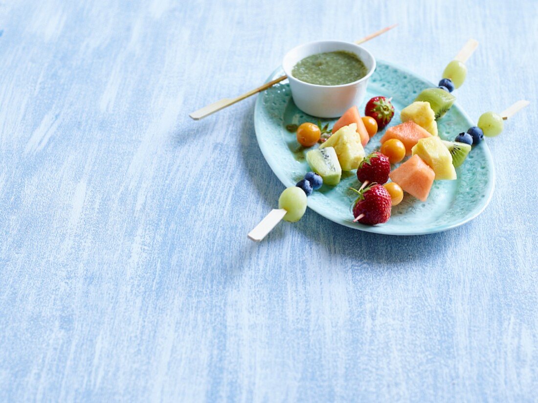 Rainbow fruit skewers with wheatgrass and chia sauce