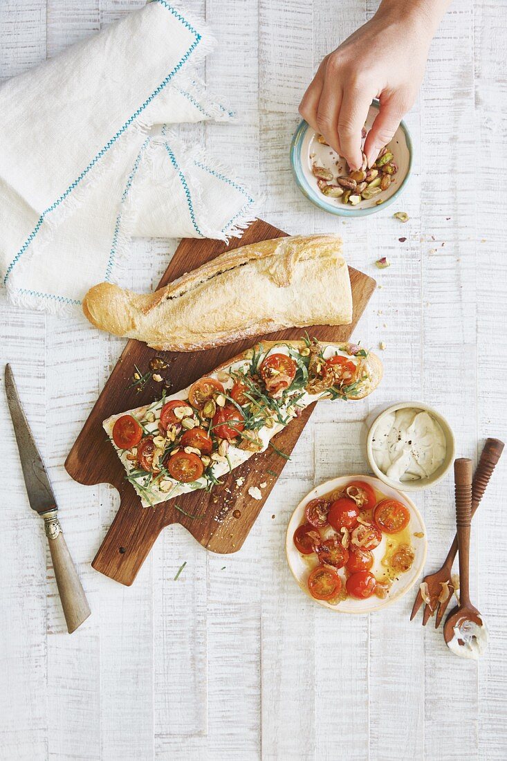 A sandwich with zaatar, pistachios and tomatoes