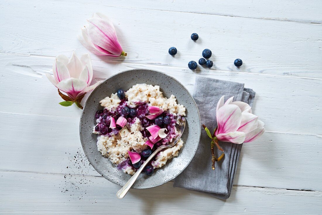 Rice pudding with blueberries and magnolia blossoms