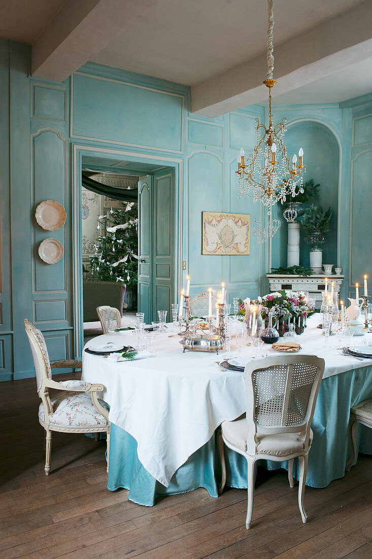 Festively set table in antique dining room with panelled walls