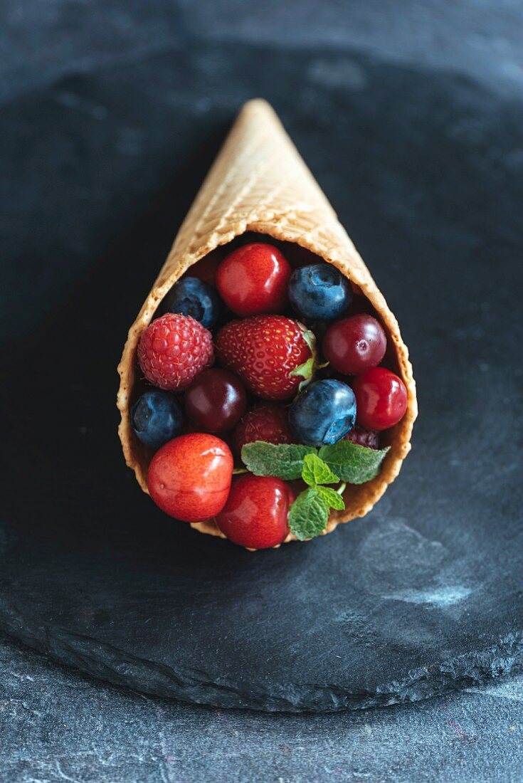 Various berries in ice cream cones
