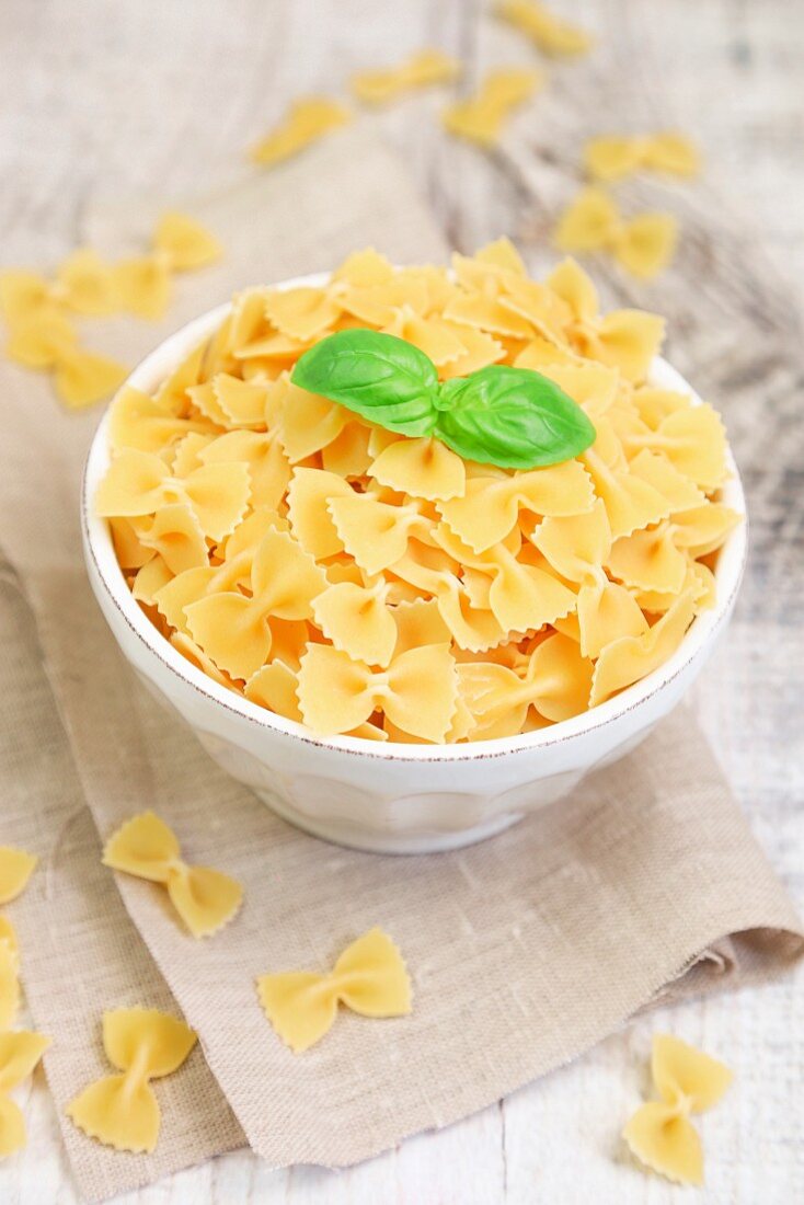 Farfalle pasta in a bowl with fresh basil