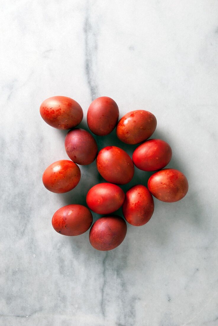 Red Greek Easter eggs on a marble background