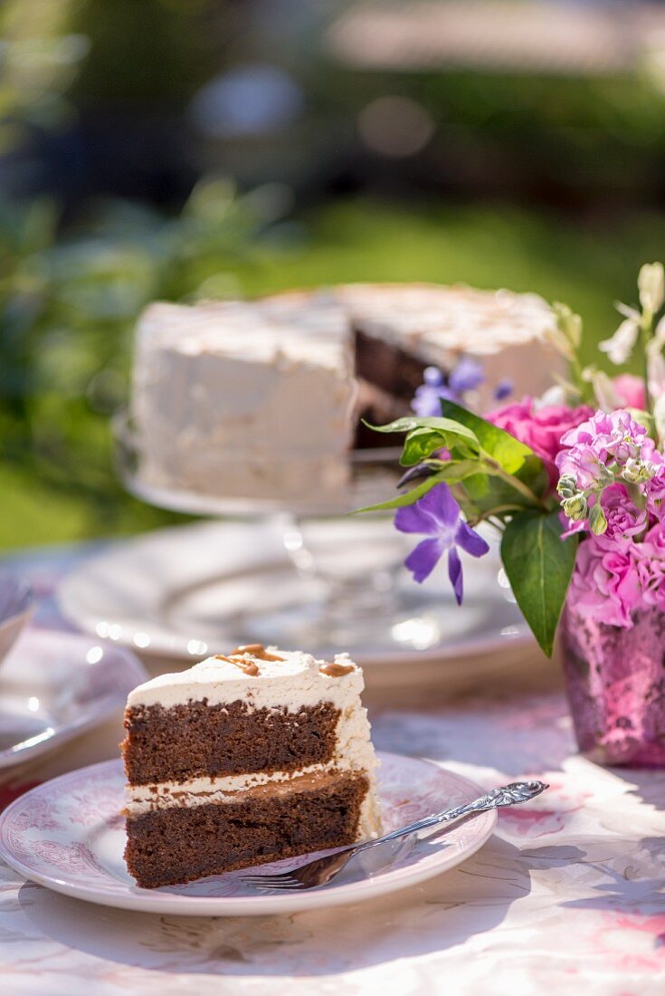 Summery chocolate sponge cake on a table outdoors
