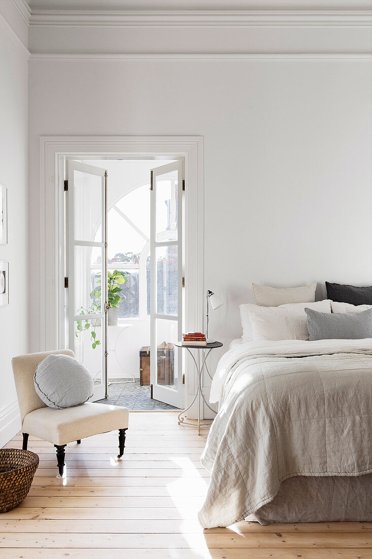 Bright bedroom with an open double door to the winter garden