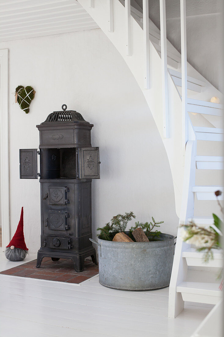 Cast iron stove below winding staircase