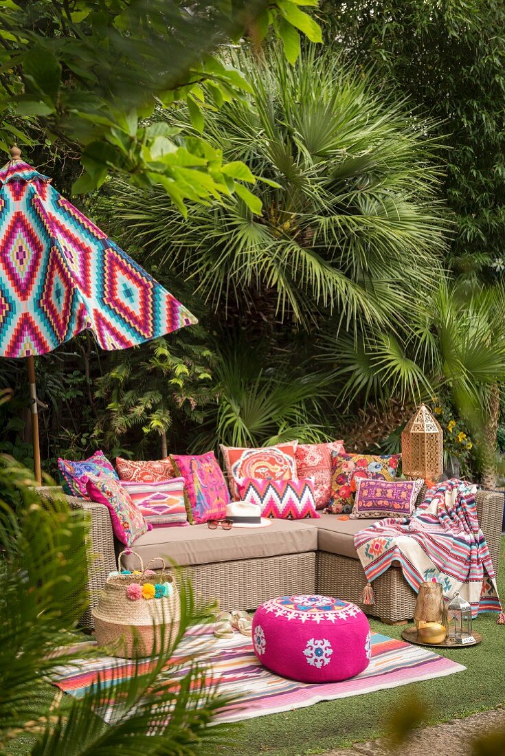 Outdoor sofa and exotic decorations in garden seating area