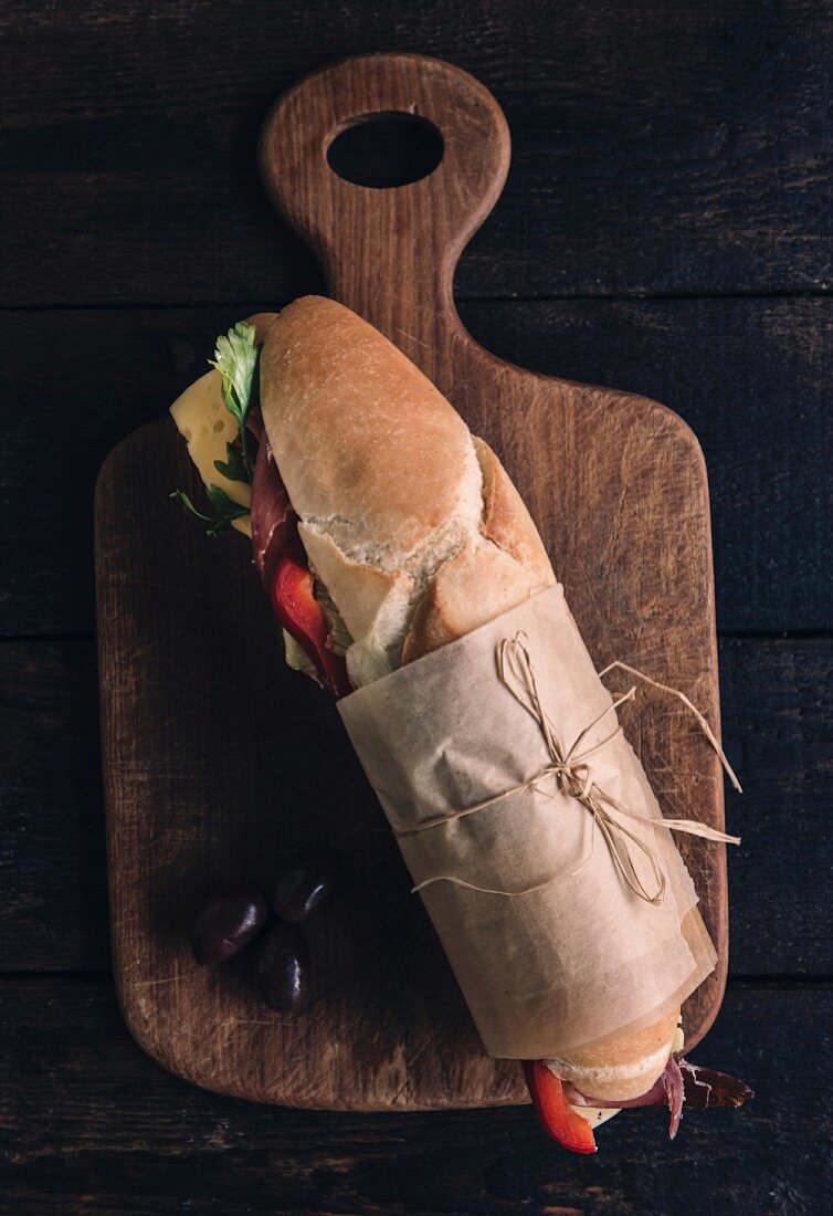 Served submarine sandwich on wooden board