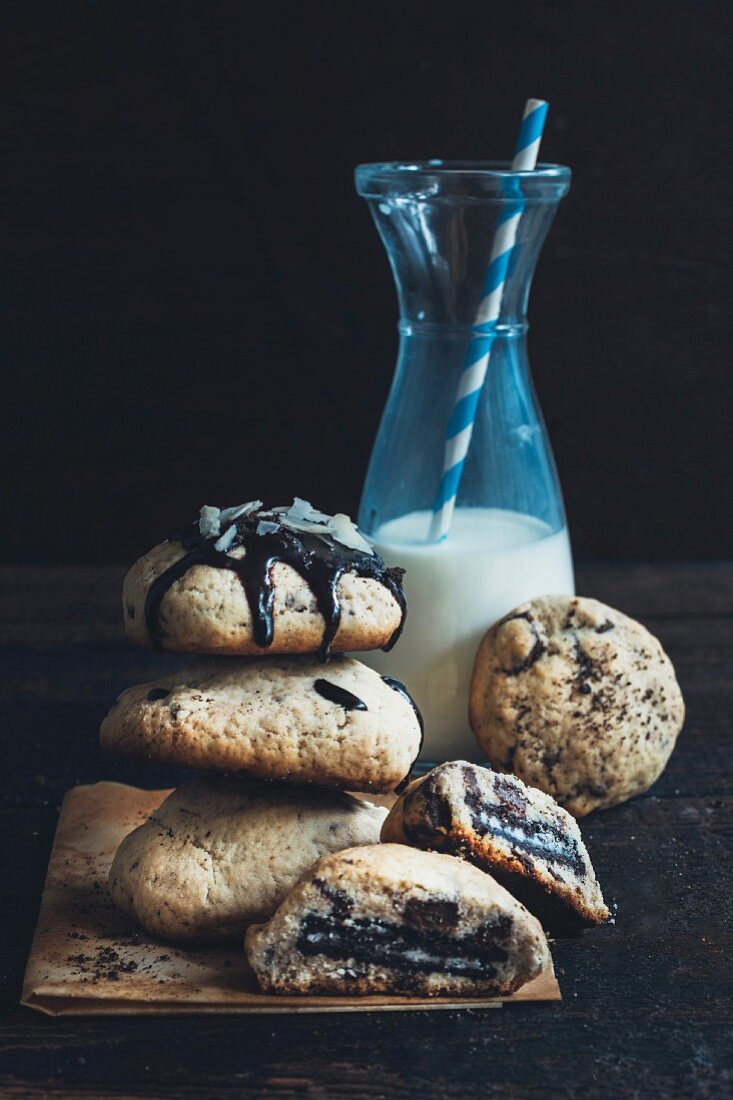 Homemade stuffed chocolate chip cookies and a bottle of milk