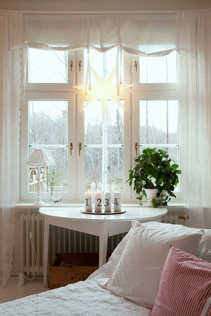 Advent candles on console table below window