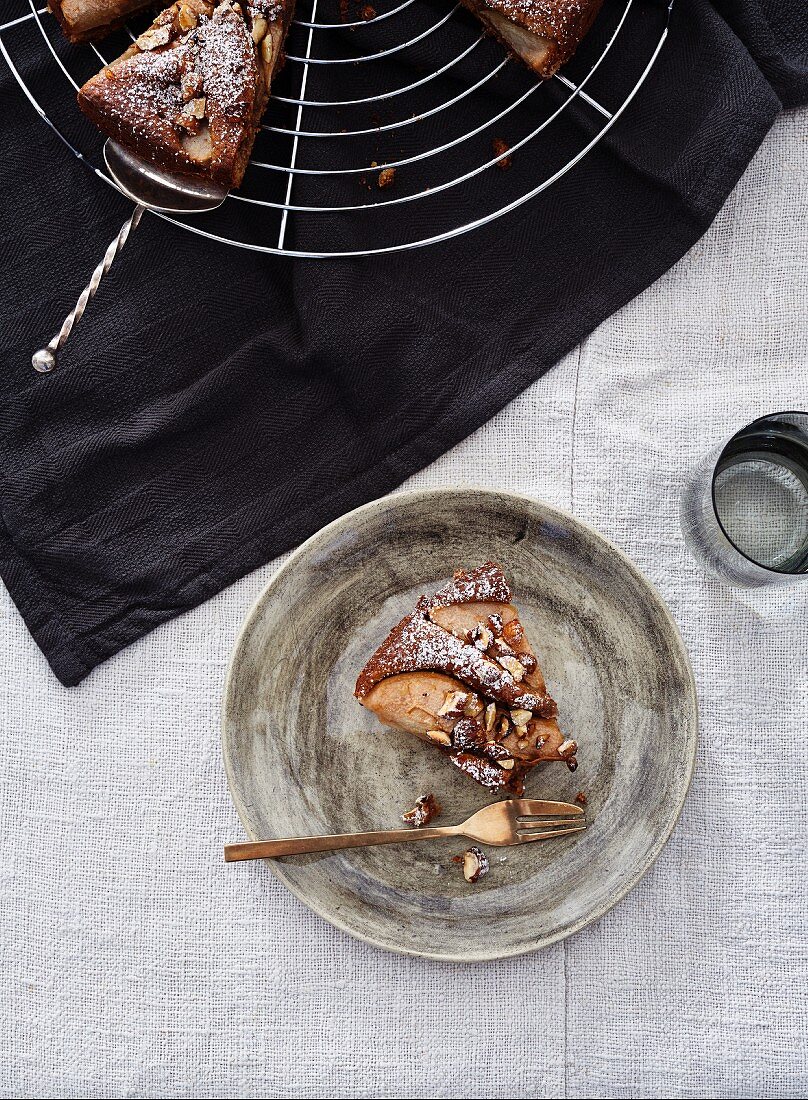 A piece of pear cake on a grey plate