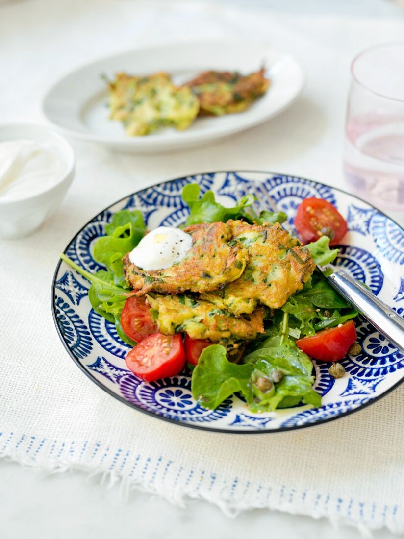 Zucchini fritters with spinach and tomatoes
