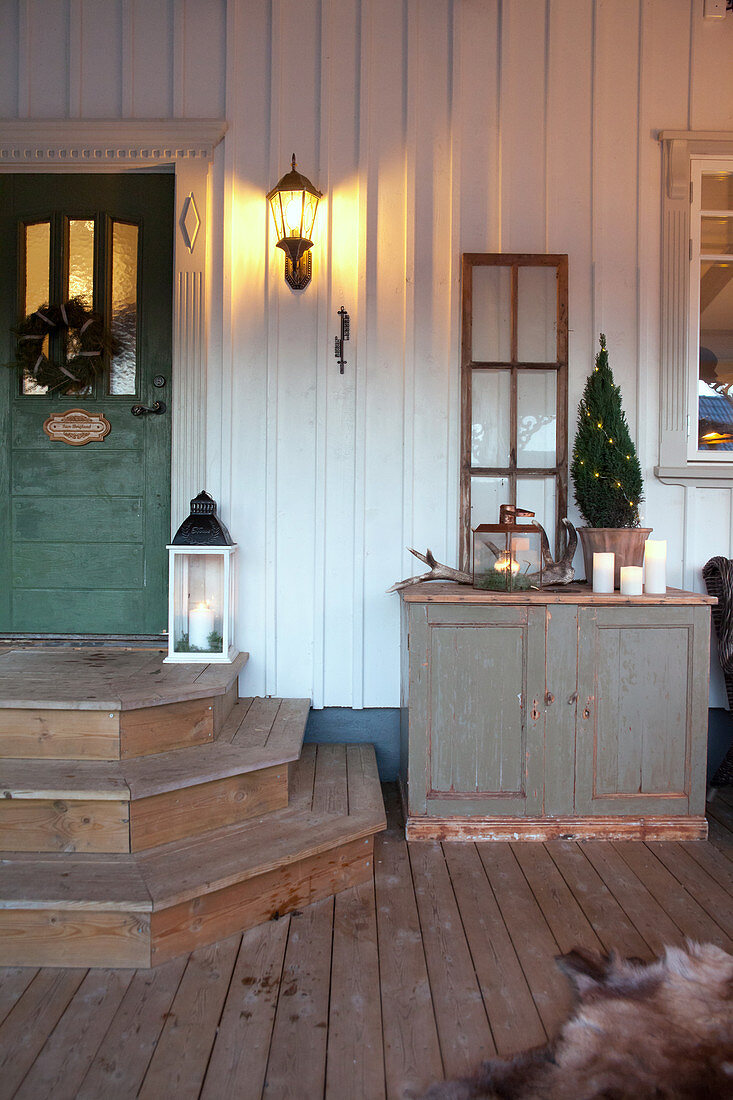 Country-house-style house entrance with rustic winter decorations