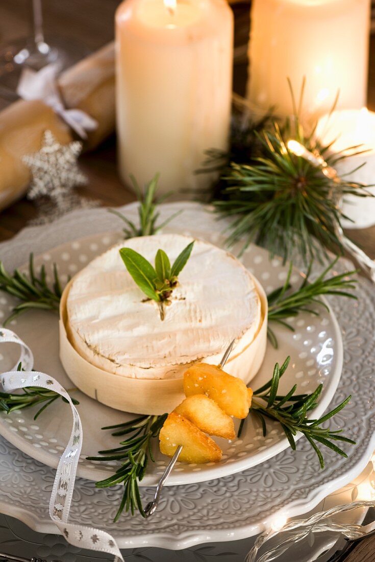 Baked camembert decorated with rosemary sprigs