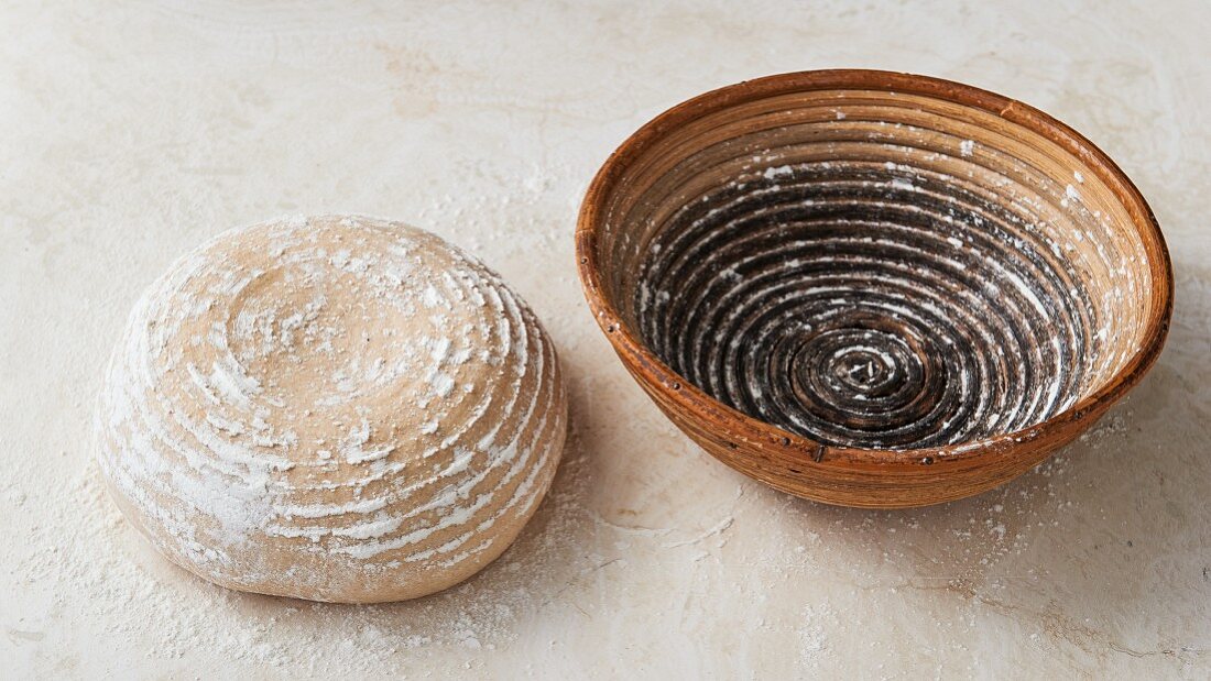 A loaf of bread and a fermenting basket