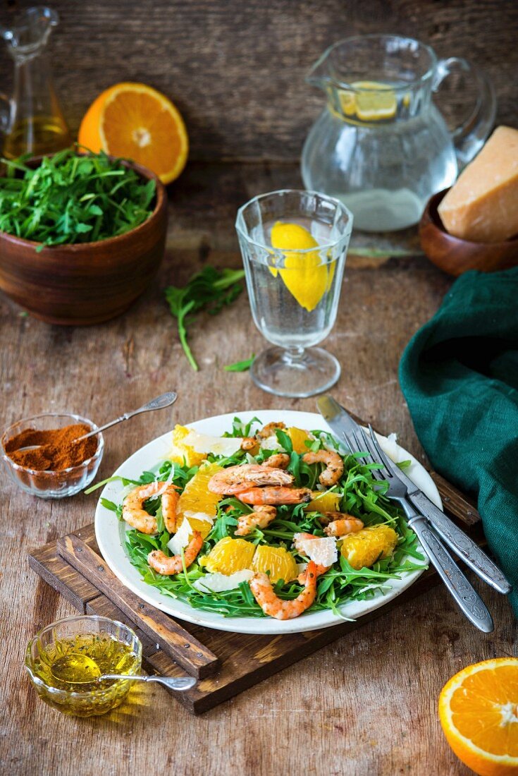 A rocket and shrimp salad with orange segments