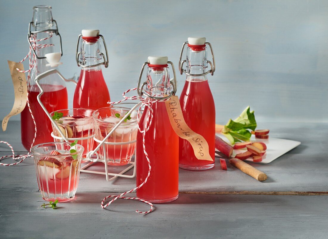 Homemade rhubarb syrup in glasses and flasks