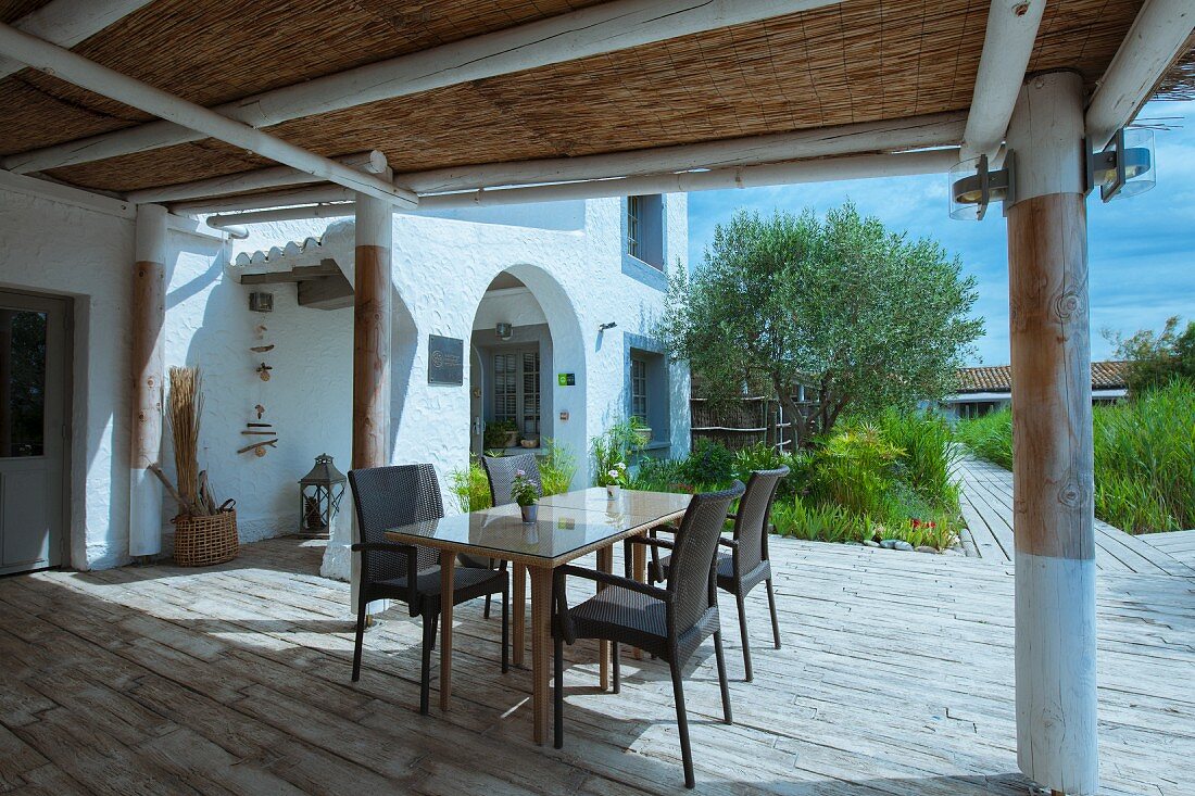 Table and chairs on terrace of Mediterranean house