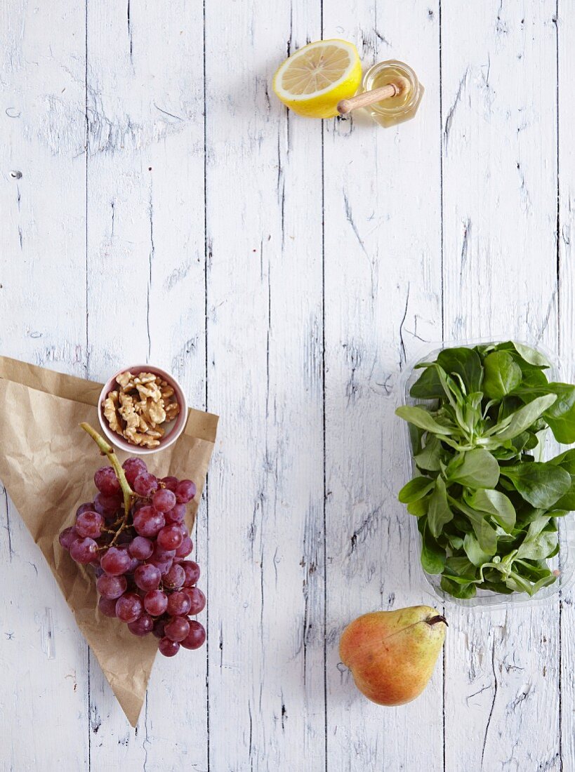 Grapes, walnut kernels, lambs lettuce and a pear