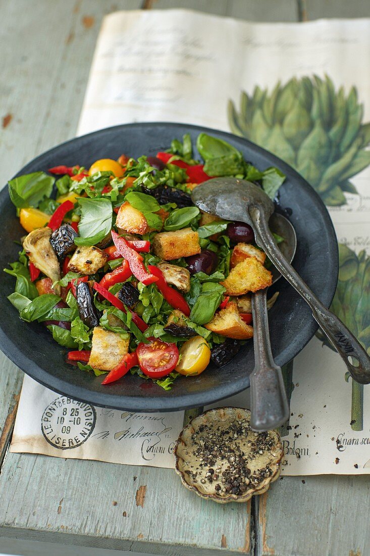 A bread salad with kale and artichokes