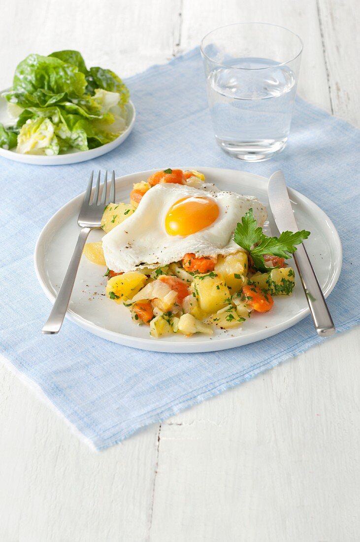 Potato, carrot, and leek ragout with a fried egg and a green salad