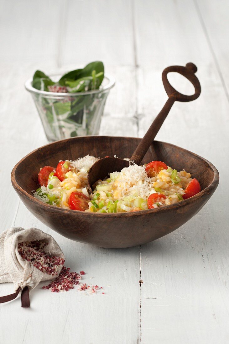 Red lentil risotto with cherry tomatoes, parmesan, and a spinach salad