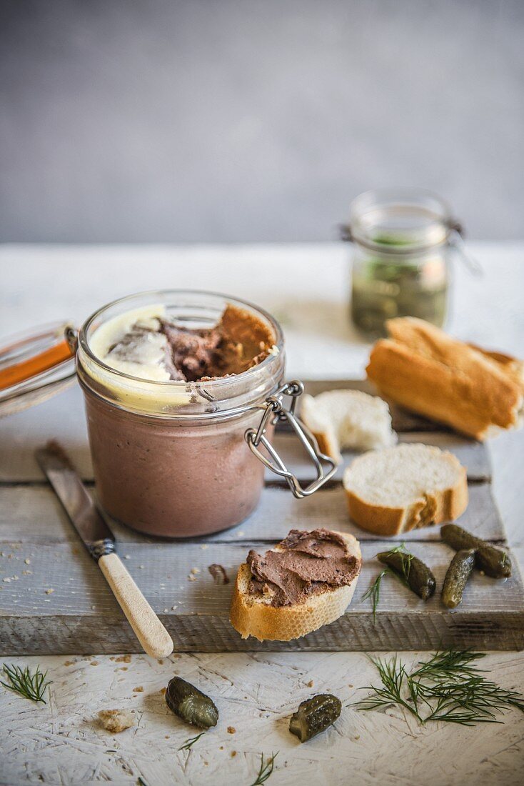 Homemade chicken liver pate with french bread and cornichons