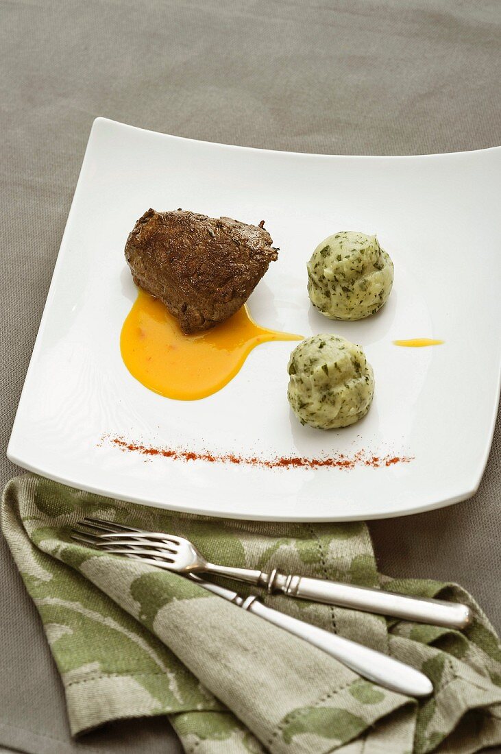 A rosemary roasted veal fillet with parsley cream and pumpkin sauce