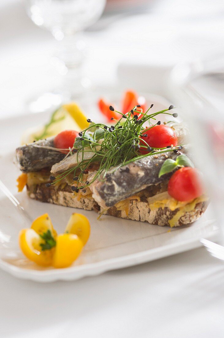 Open sandwiches with sardines and cherry tomatoes