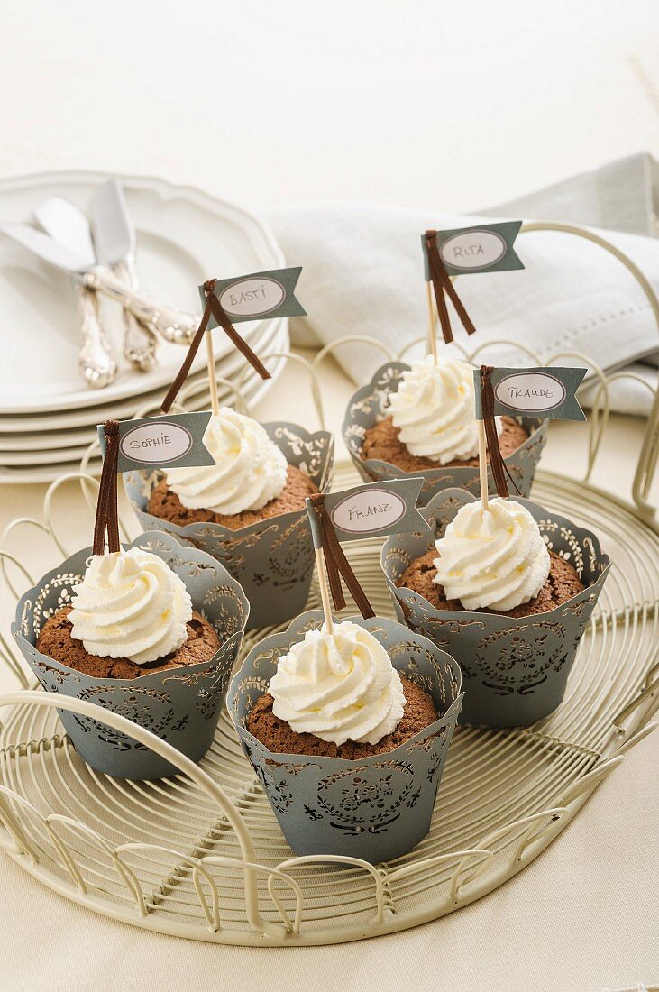 Chocolate cupcakes with whipped cream and small labels