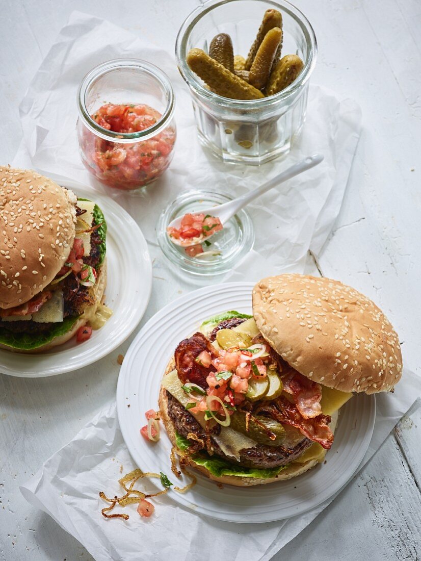 Burgers with bacon, tomato salsa, and gherkins