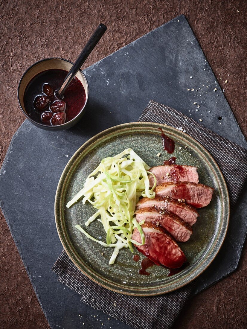Sliced duck breast with creamed cabbage and sour cherry sauce