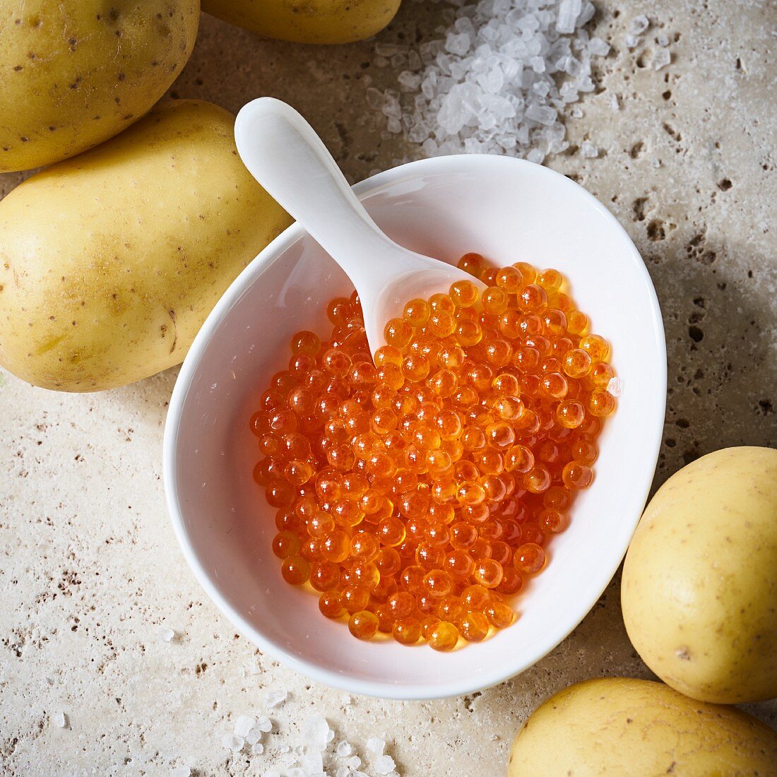 Trout caviar with a spoon in a small bowl