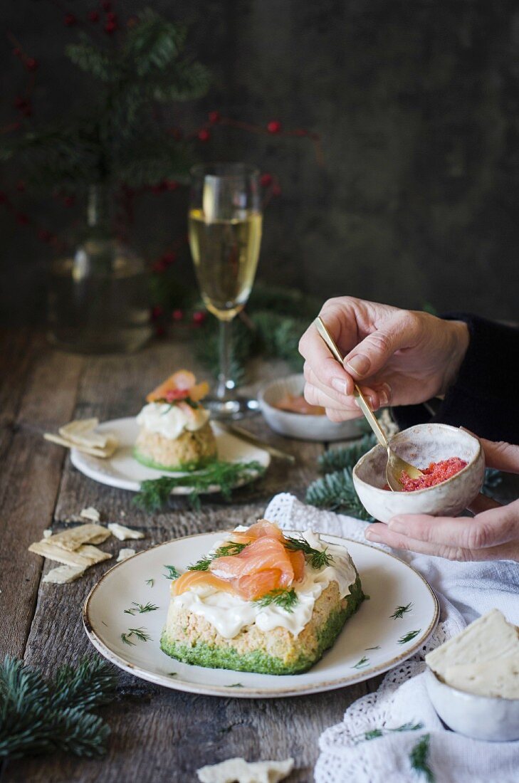 Small salmon cakes being garnished