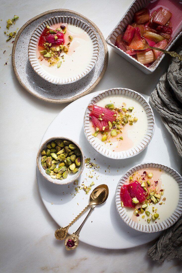 Panna cotta topped with roasted rhubarb and chopped pistachios