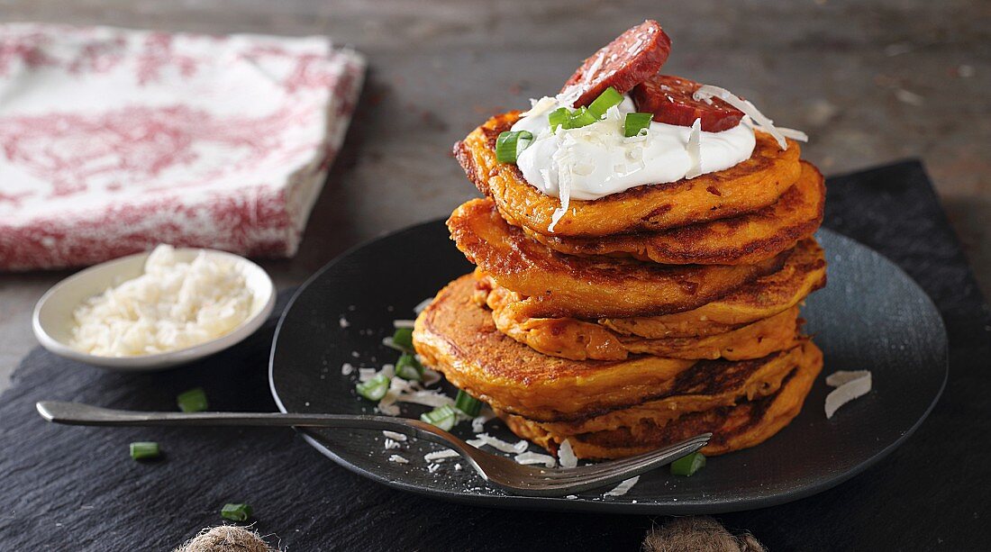 Pumpkin pancakes with sour cream and sausages