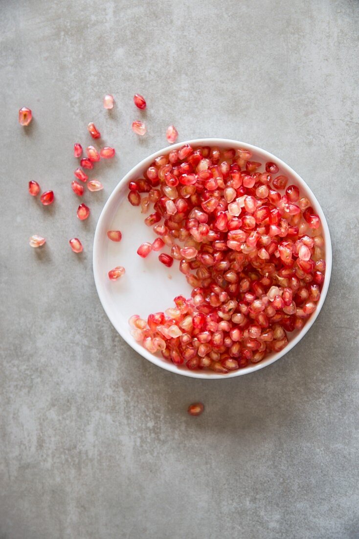 Pomegranate seeds in a small bowl