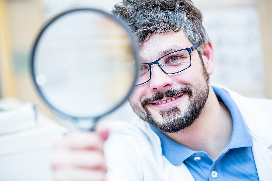 Optometrist holding magnifying glass