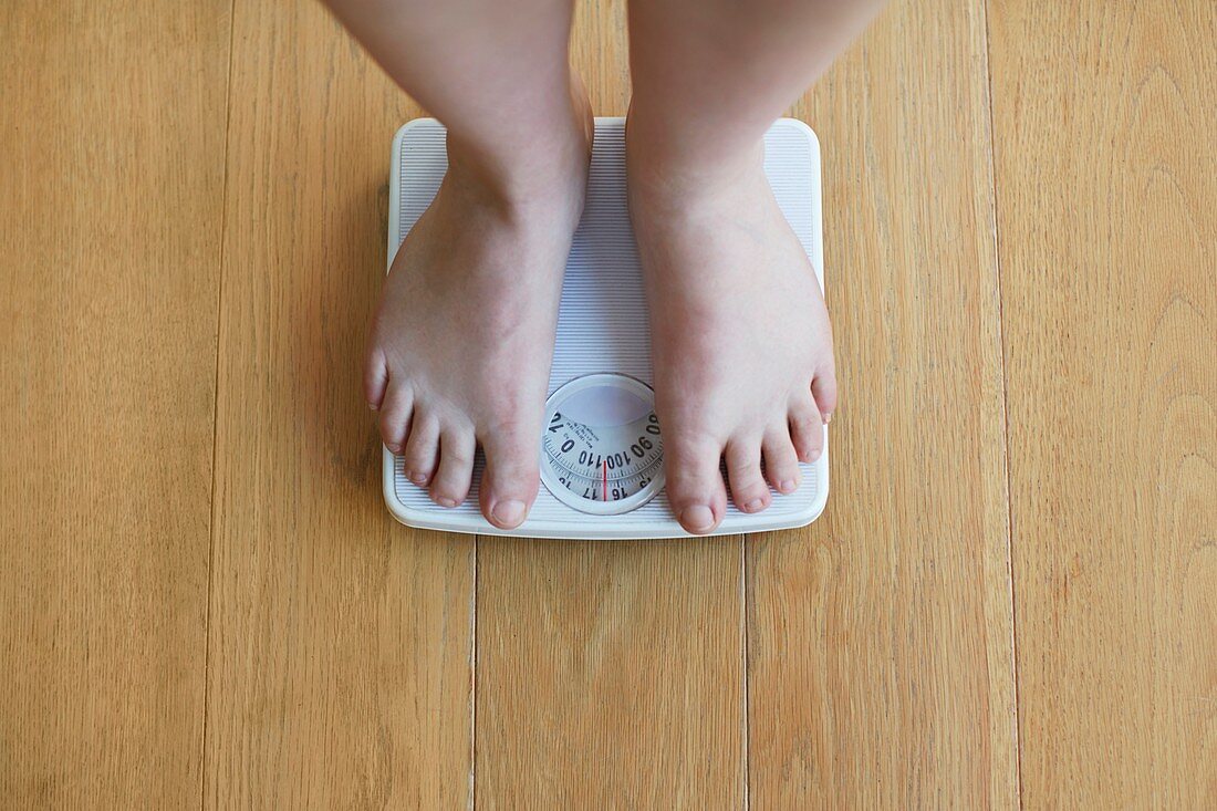 Woman standing on weighing scales