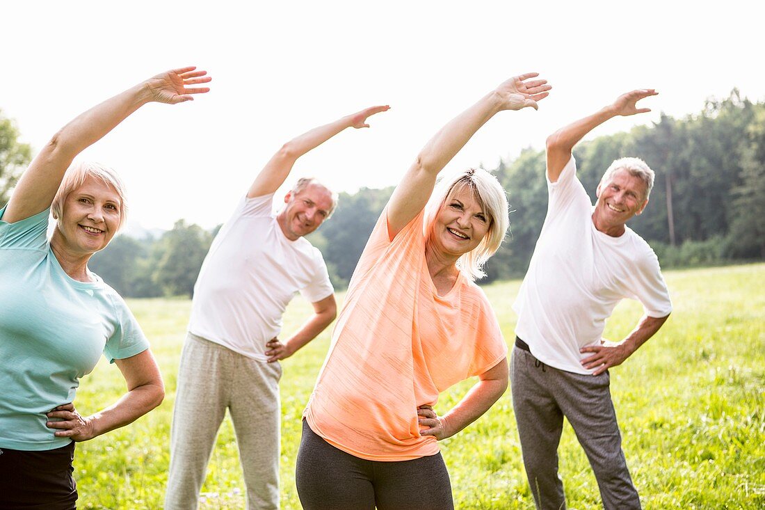 Four people in field exercising