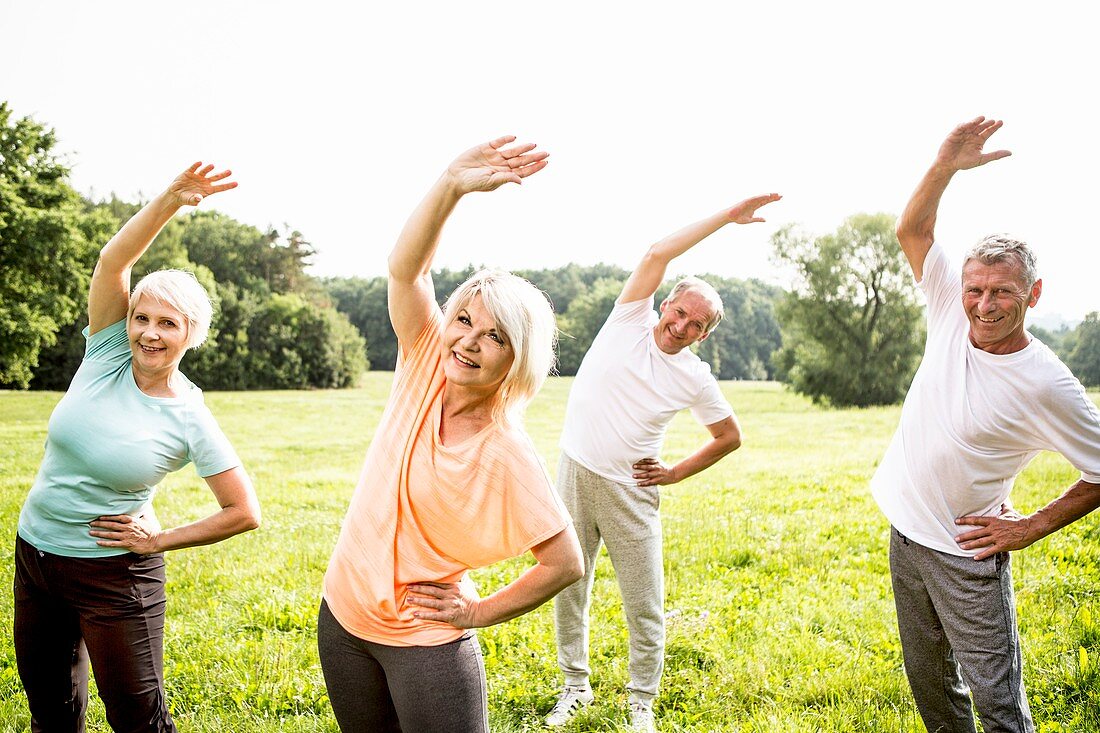 Four people in field exercising