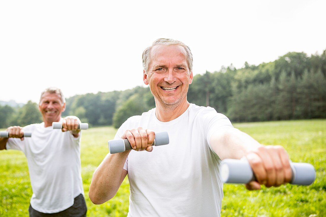 Two men exercising with hand weights