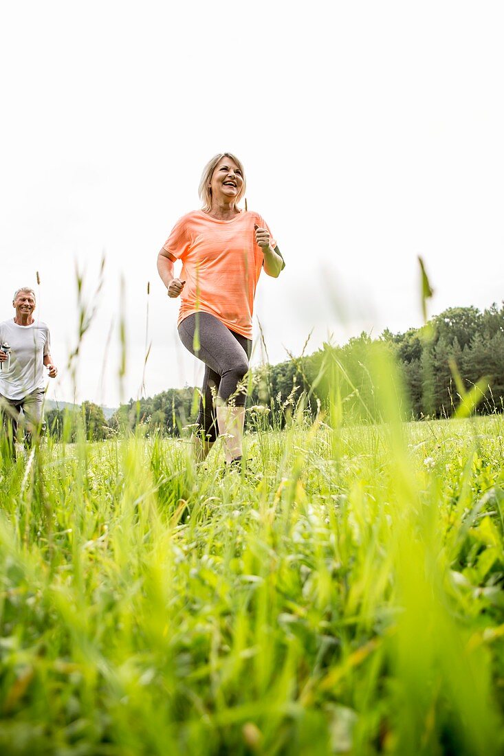 Mature woman jogging in grass