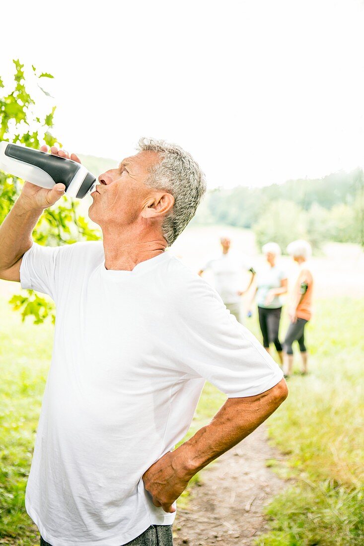 Man drinking water from sports bottle
